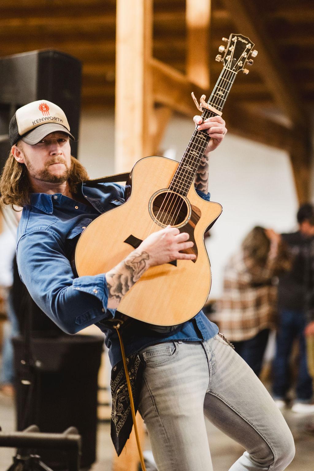 Live country music performance at the Bourbon & Bacon Social event at The Meadow Barn in Harrisburg SD