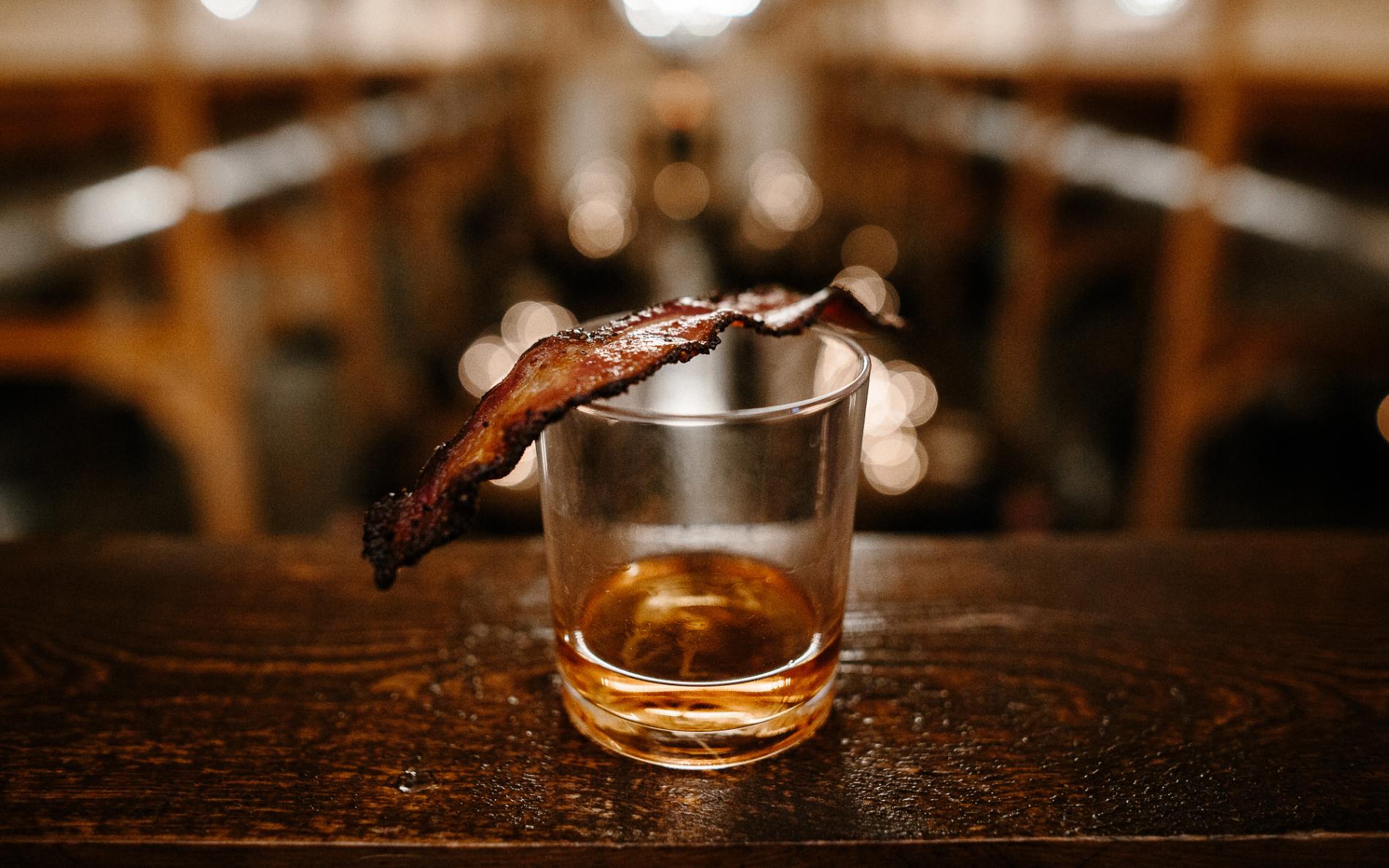 Bourbon cocktail with crispy bacon garnish served at The Meadow Barn Bourbon & Bacon Social in Harrisburg South Dakota